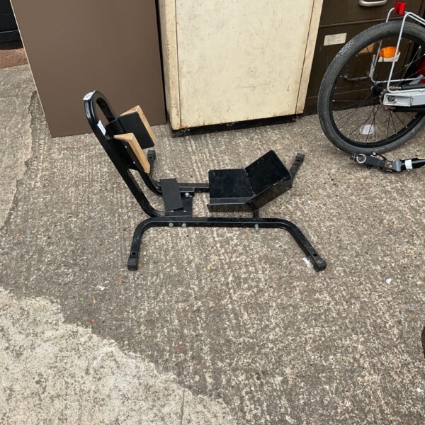 Black motorcycle wheel chock for front wheel stability.