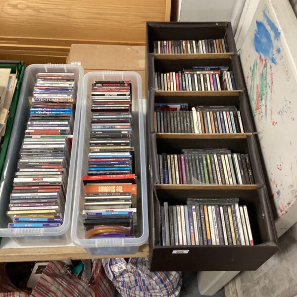 Large music CD collection in storage boxes, including ELO and Aerosmith.