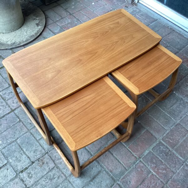 Vintage Nathan teak nest of tables in a home setting.