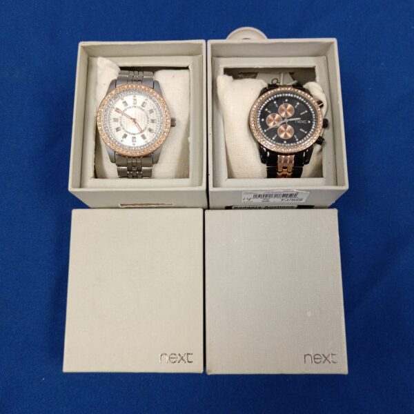 Pair of silver-tone Next ladies watches with crystal details.