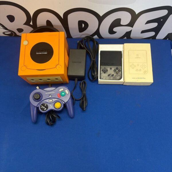 Spicy orange Nintendo GameCube console with controller and Anbernic device.