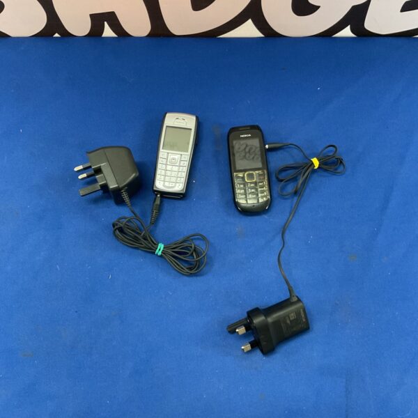 Two vintage Nokia mobile phones with chargers displayed on a blue background.