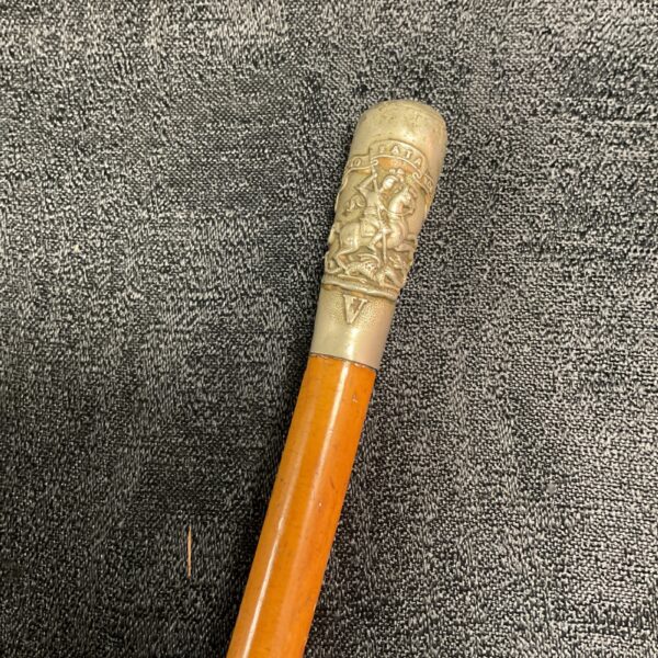 Detailed brass top of a Northumberland Reserve swagger stick.
