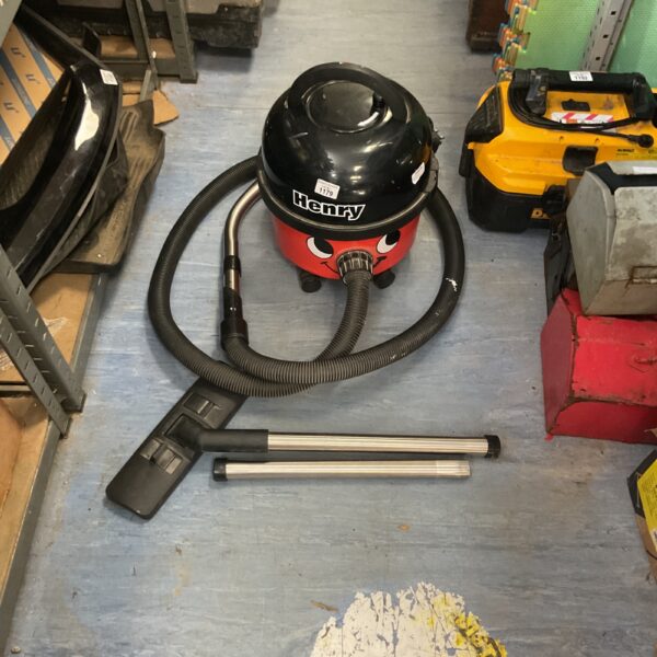 Red Numatic Henry HVR 200 canister vacuum cleaner with hose.