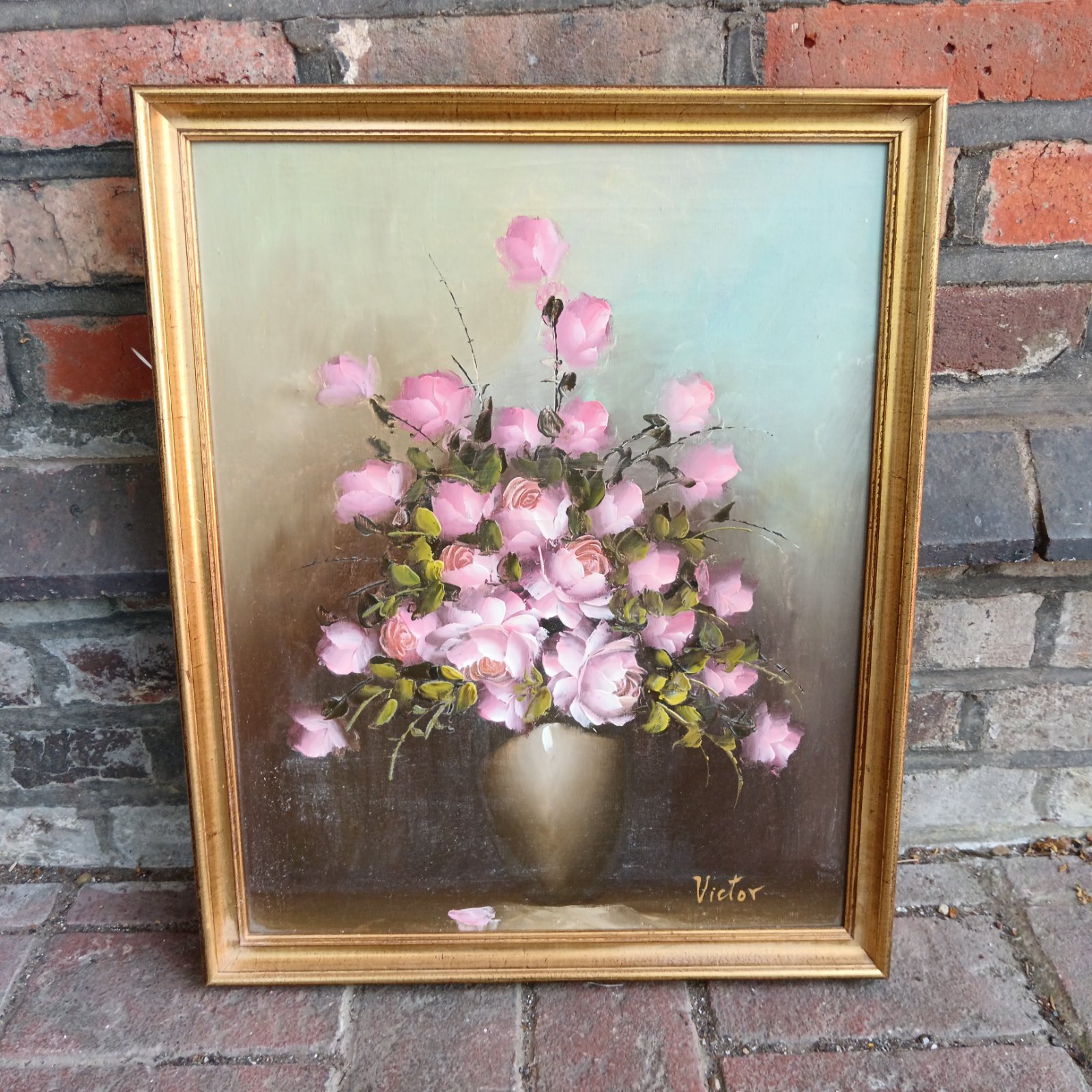 Vintage oil painting of pink roses in a gilt frame, signed Victor.
