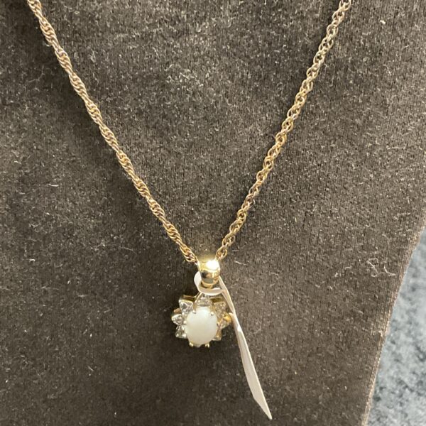 Vintage opal pendant necklace with floral design.