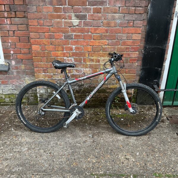 Side view of a vintage Orange G3 mountain bike.