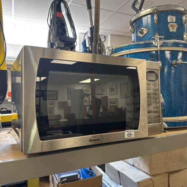 Stainless steel Panasonic microwave with turntable inside.