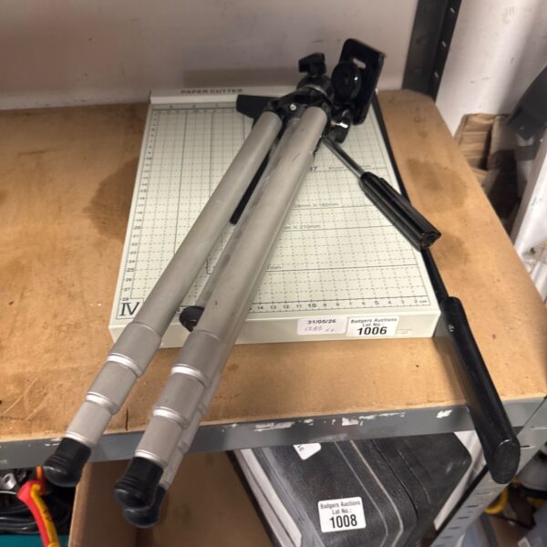 Vintage paper cutter with tripod stand for precise trimming.