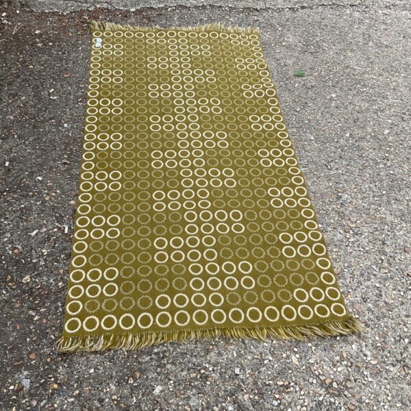 Dark olive and vanilla Pappelina Noa runner with geometric pattern.