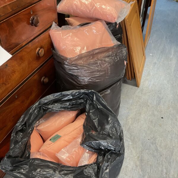 Black bags filled with patio furniture cushions for outdoor use.