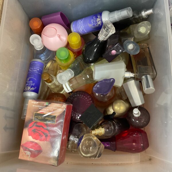 Assorted vintage perfume bottles in a box, collectible fragrance containers.