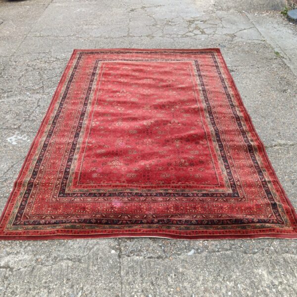Red Persian rug with floral patterns, handwoven Keshan wool.