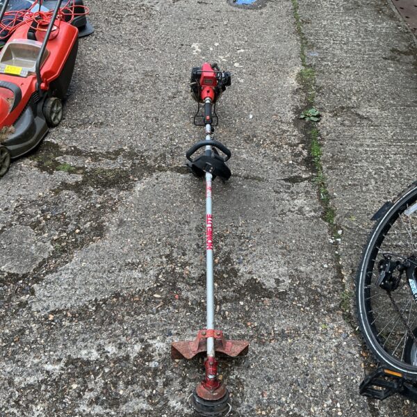 Used petrol strimmer for garden maintenance, requiring repair.