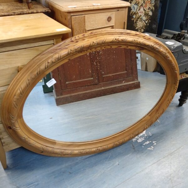 Chunky pine framed oval mirror for rustic home decor.