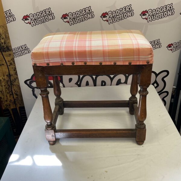 Vintage plaid upholstered stool with turned wooden legs.
