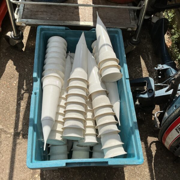 Bulk lot of plastic flower vases for displays and crafting.