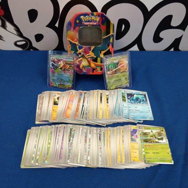 Pokemon tin with holographic cards and EX cards inside.
