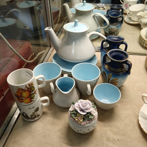 Vintage Poole Pottery collection featuring a teapot and Greek key urns.