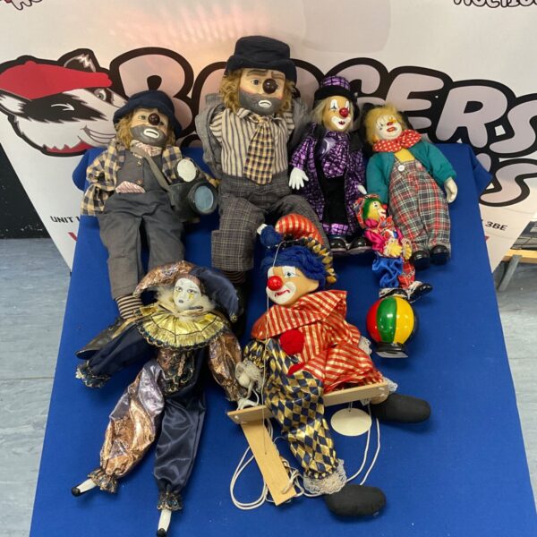 Vintage porcelain clown dolls collection, colourful and detailed figurines.