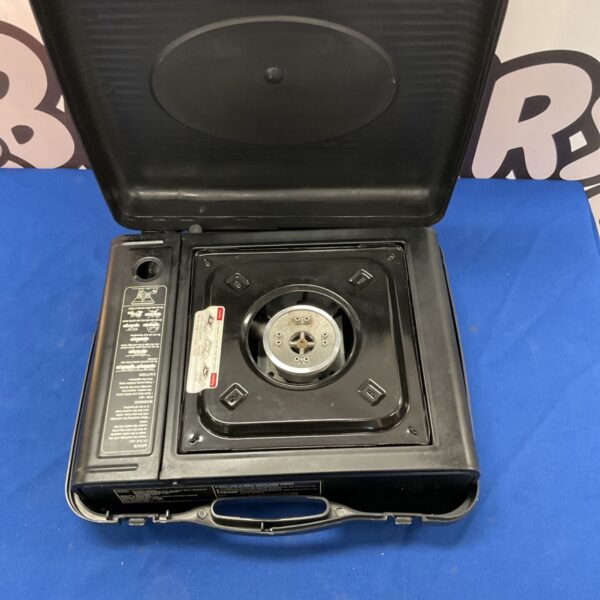 Portable butane camping stove for outdoor cooking.