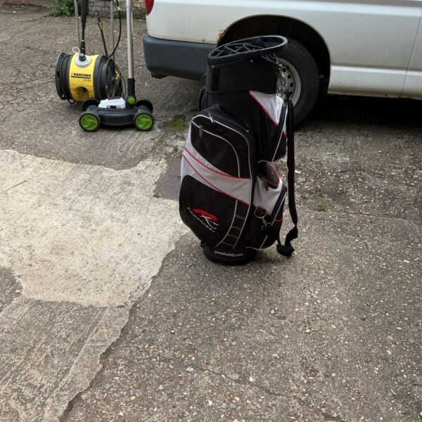 Exterior view of a used Powerkaddy golf bag with trolley handle.