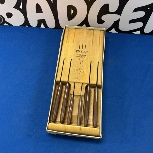 Vintage Prestige Hollow Ground knives with wooden handles.