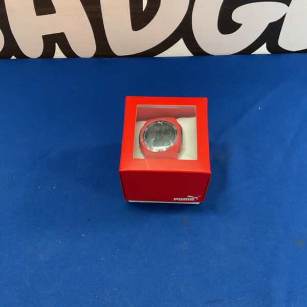 Red Puma sports watch with digital display, ideal for fitness.