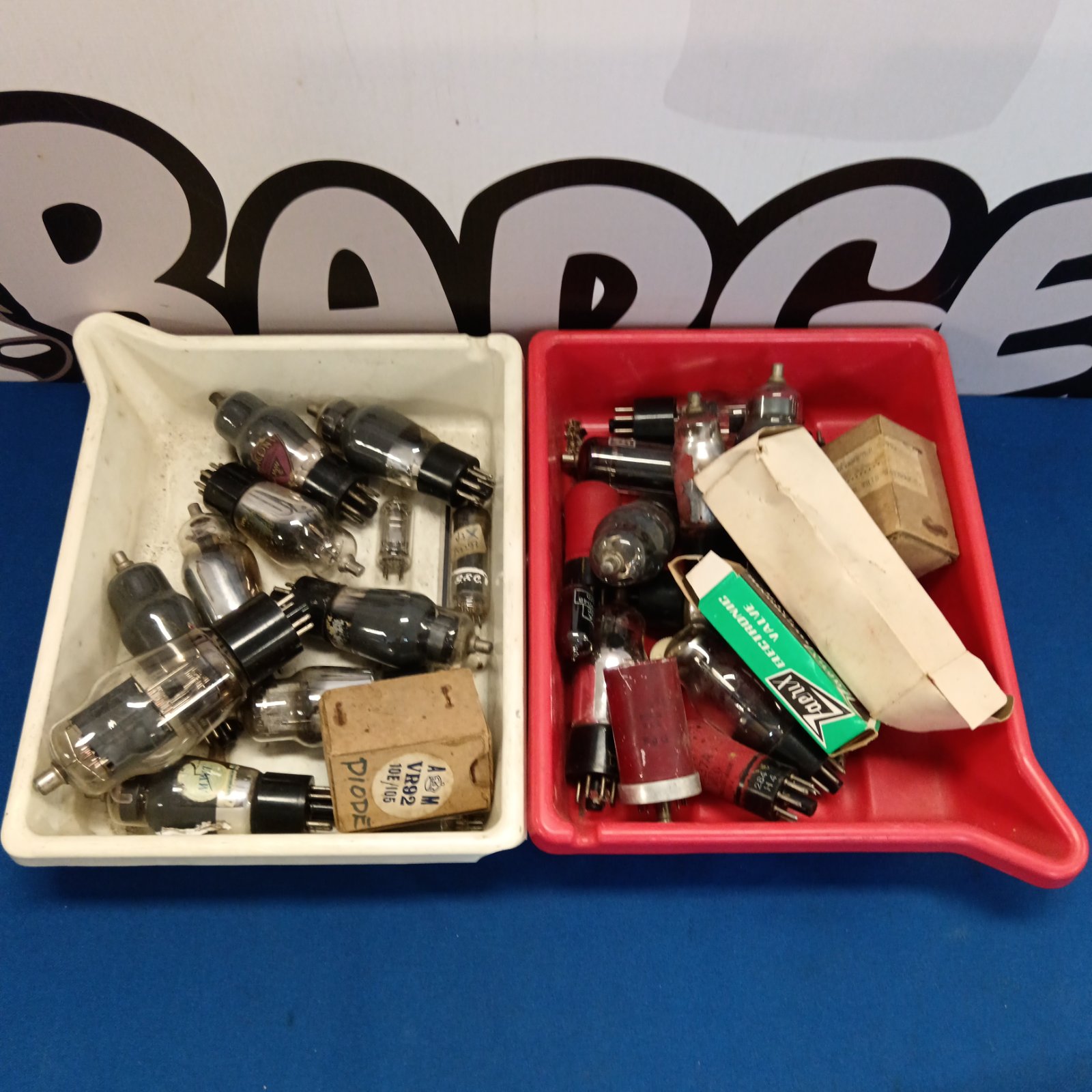 Assorted vintage radio valves in a tray, a collector's item.