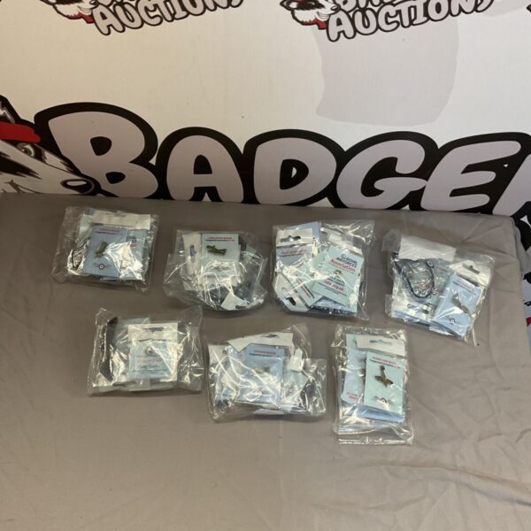 Sealed bags of RAF pin badges, a military collectible.