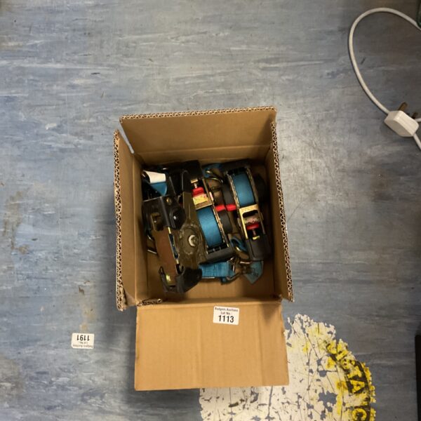 Box of auto retractable ratchet tie down straps for cargo securing.