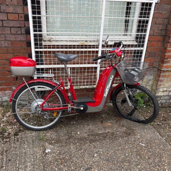 Red Veloster electric bicycle with basket and rear rack.