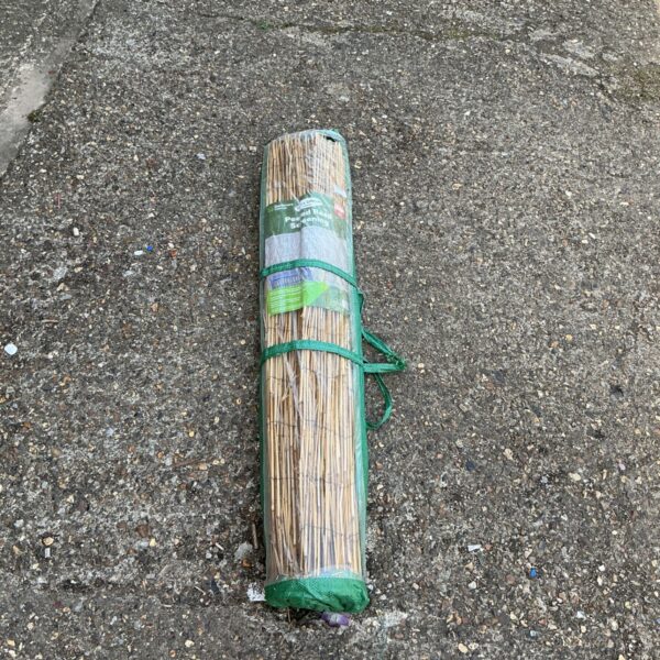 Roll of natural reed screening for garden privacy.
