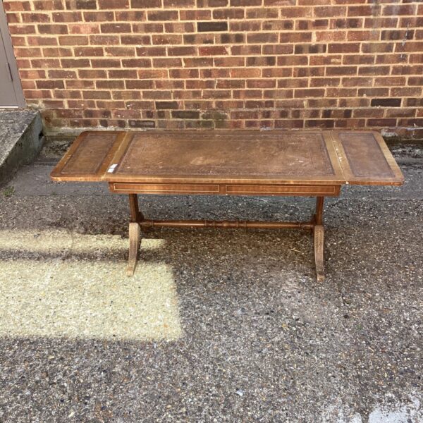 Antique Regency drop leaf table with leather top and mahogany frame.