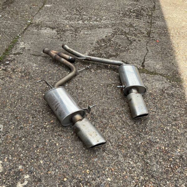Polished stainless steel Remus exhaust pipes for car modification.