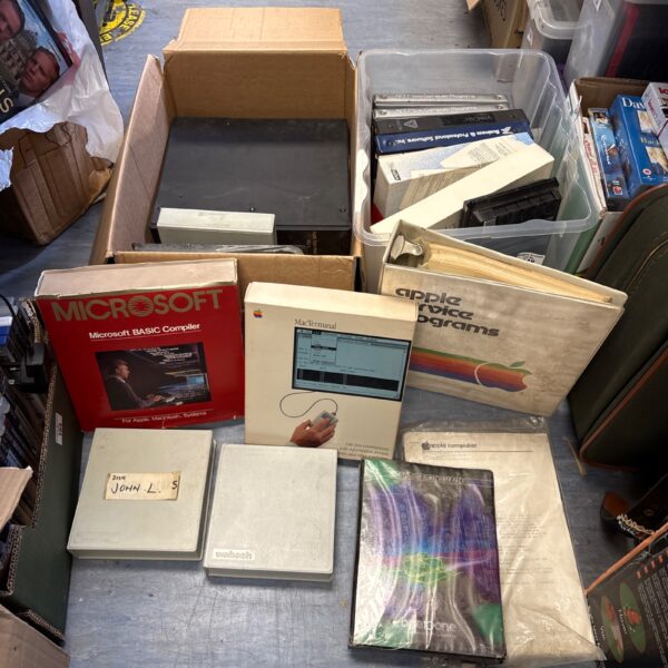 Lot of vintage retro computing software including Microsoft and Apple diskettes.