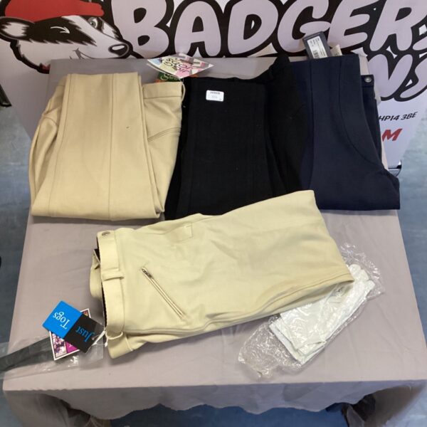 Equestrian clothing lot featuring riding trousers and gloves.