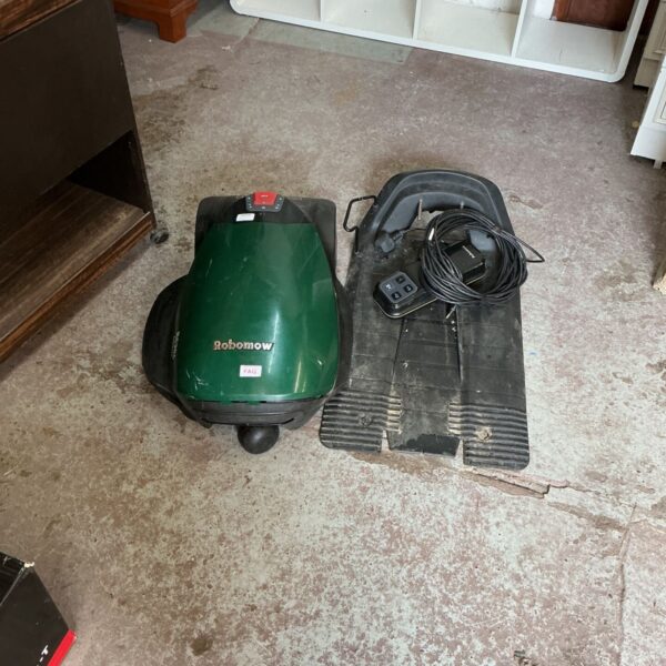 Robomow lawn mower with charging base and remote control.