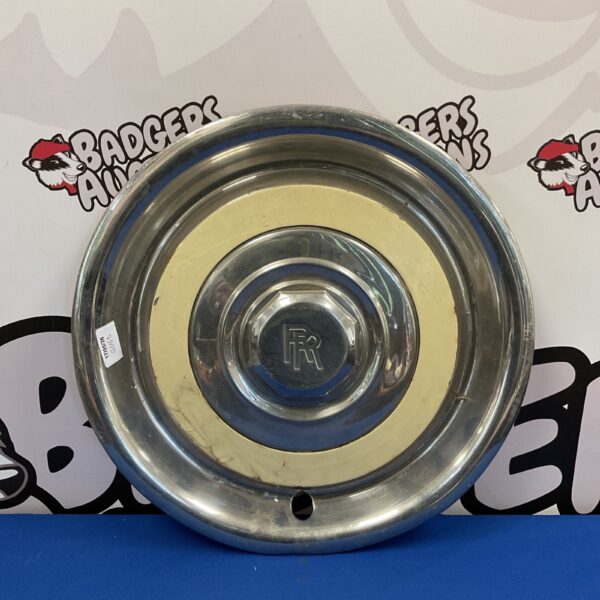 Vintage Rolls Royce hub cap with iconic emblem.