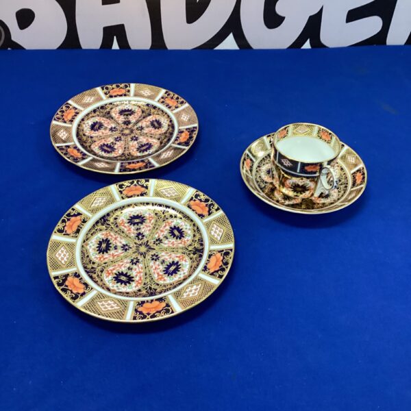 Royal Crown Derby Imari coffee cup, saucer, and plates set.