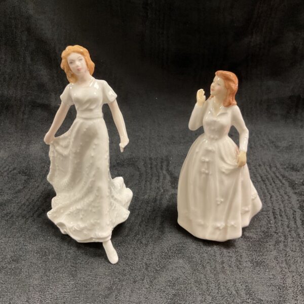Royal Doulton figurines "Friendship" and "Joy" porcelain collectibles.