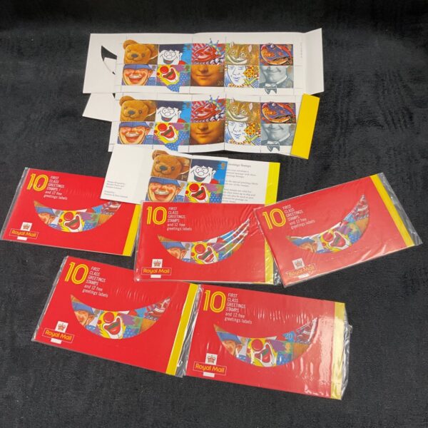 Sealed and opened packets of Royal Mail first class stamps for collectors.