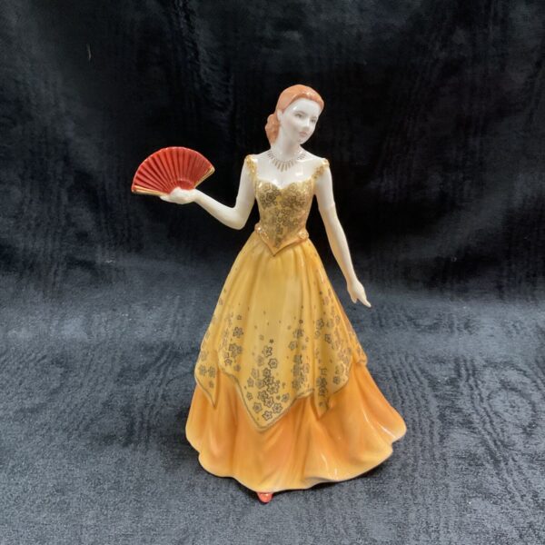 Royal Worcester Lauren figurine in yellow and gold dress.