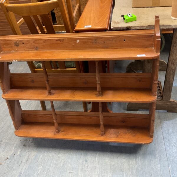 Rustic pine hanging bookshelf with three tiers for farmhouse decor.