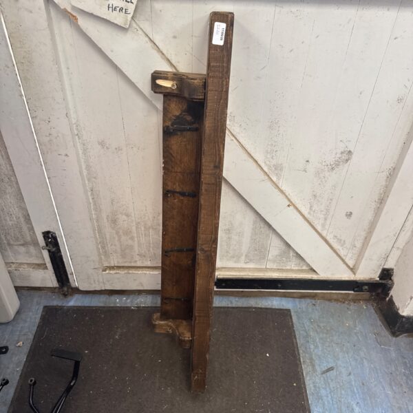 Rustic wooden wall shelf against a white door.