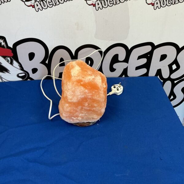 Himalayan salt crystal lamp with a warm glow.