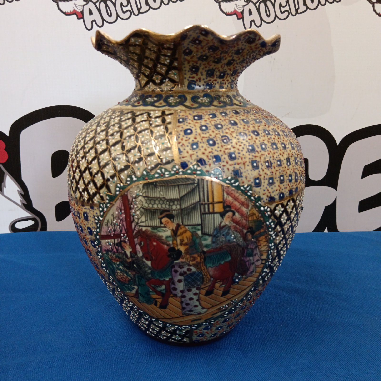 Hand-painted Satsuma vase with geisha scene and intricate details.