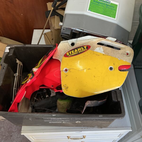 Yellow fuel tank from a vintage scrambler bike.