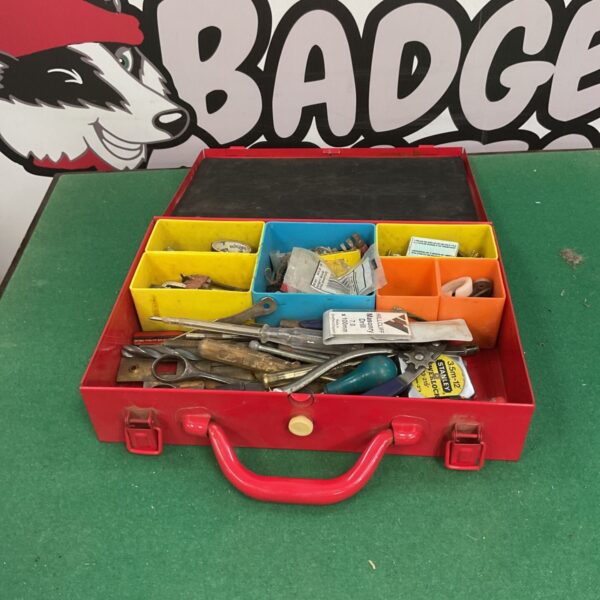 Red metal Screwfix toolbox filled with tools and fixings.