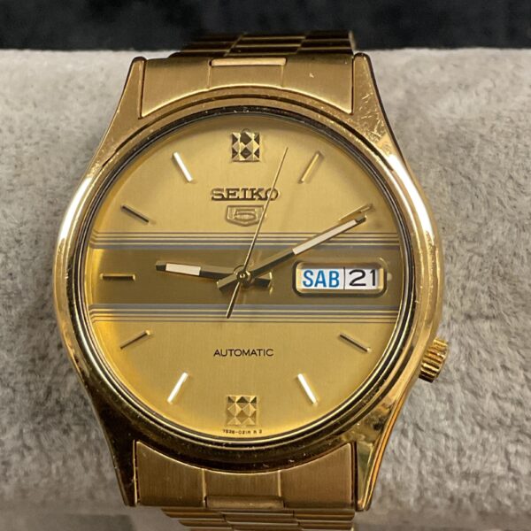 Vintage gold Seiko 5 automatic wristwatch with a classic dial.